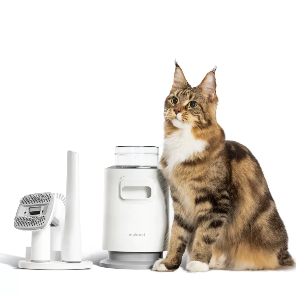 The Neakasa N0 Pro/Lite Pet Grooming Vacuum with a cat sitting next to it.