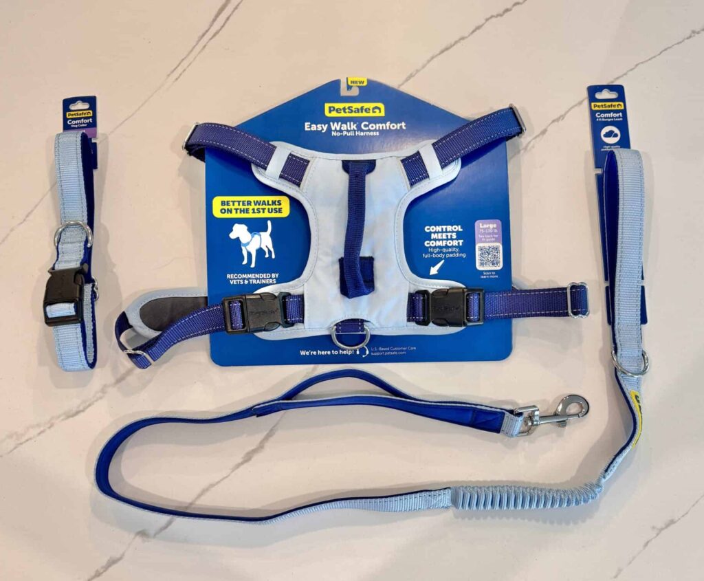 The PetSafe Easy Walk Comfort No-Pull Dog Harness, Nylon Collar, and Bungee Leash set in sky blue with royal blue straps and padding on royal blue cardboard displays.